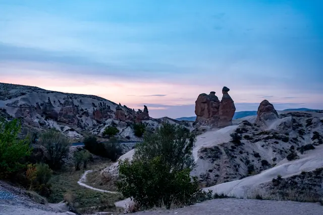 A hilltop town crowned by a castle at dusk.