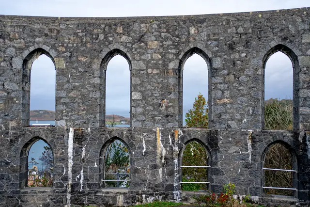 Sunlight through the arches of a ruined stone monument.
