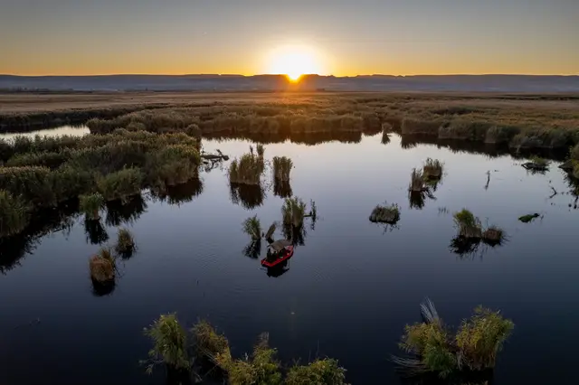 An aerial sunset over reed-filled wetlands in Turkey.