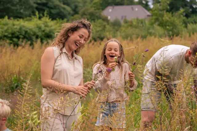 A family together in a summer wildflower meadow.